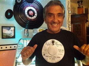 Pat Benti wears a T-shirt displaying his 1971 single “From Sunset until Dawn,” recorded before he began as lead vocalist of the popular Sha Boom Band.