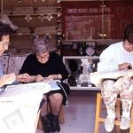 Women craft lace tablecloths by hand 