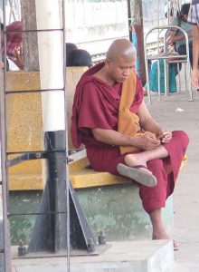 A monk uses a cell phone. Photo Victor Block